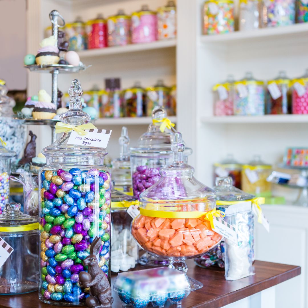 glass containers filled with candy on shelves