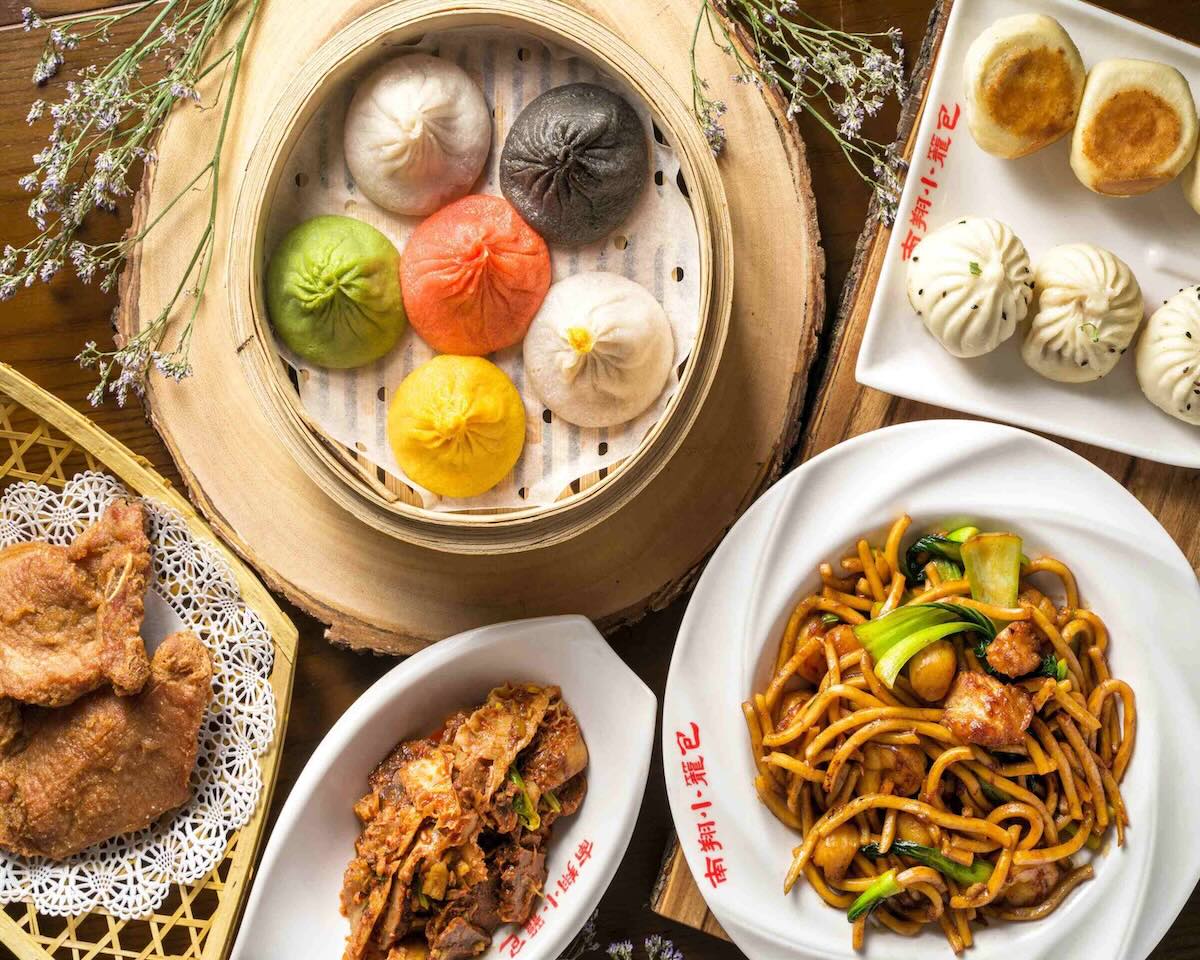 table with plates of dumplings and other dishes