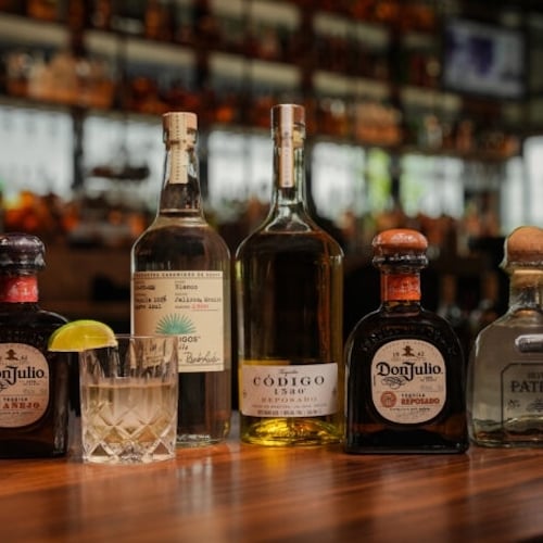 line of bottles of tequila on a bar