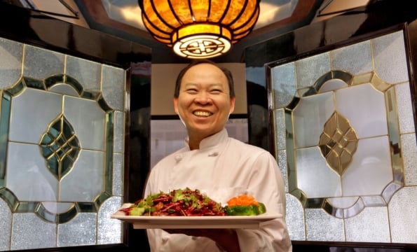 peter chang holding a plate of food