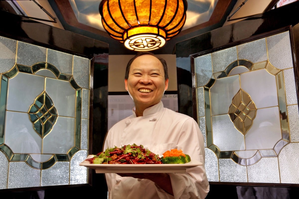 peter chang holding a plate of food