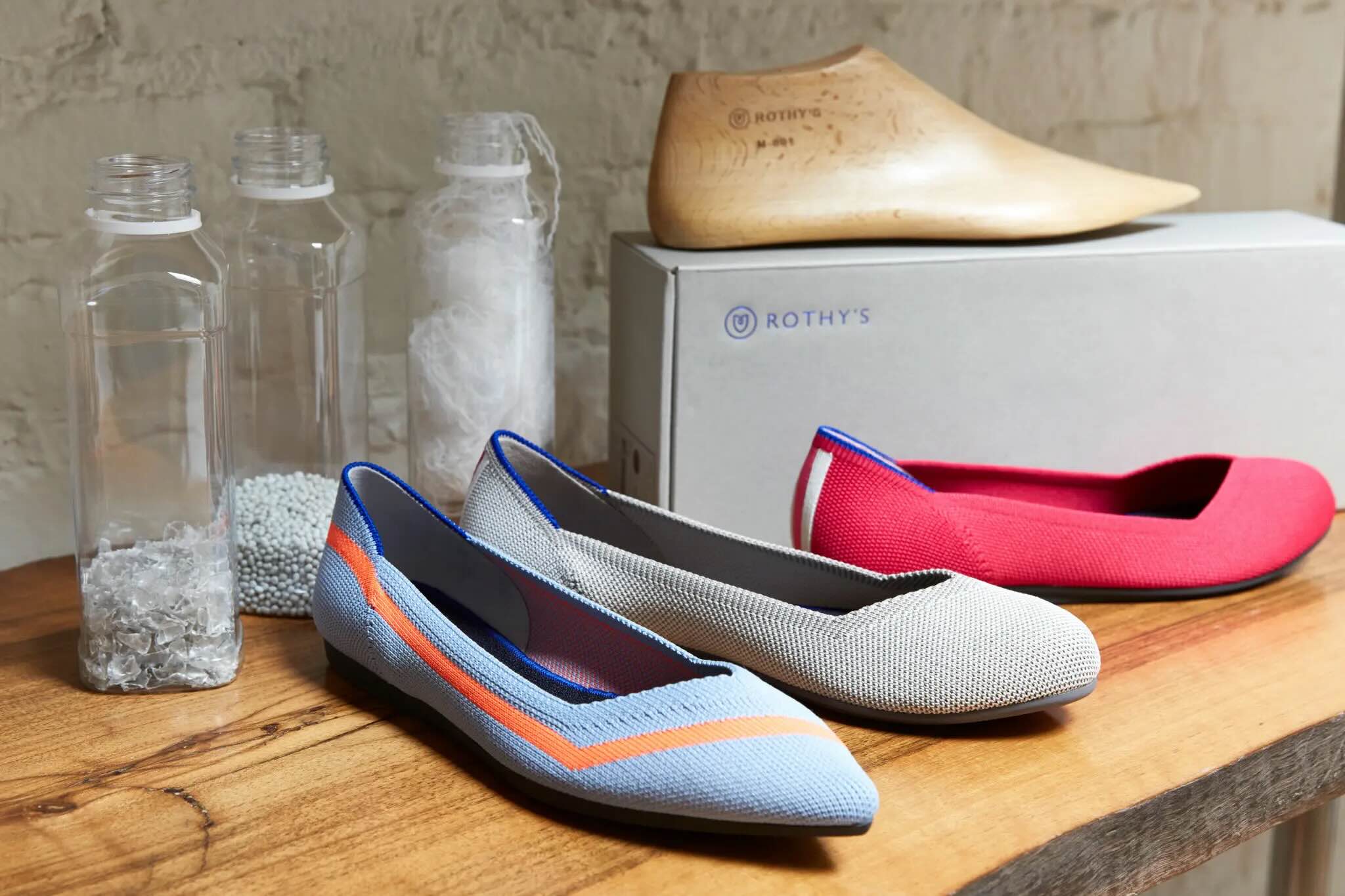 line up of shoes with plastic bottles in the backgrouond