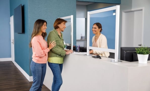 People standing at a counter in a blue room