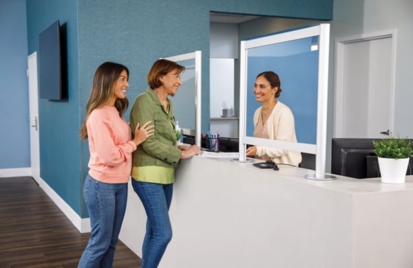 People standing at a counter in a blue room