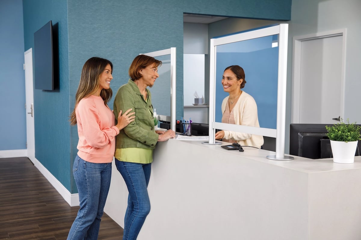 People standing at a counter in a blue room