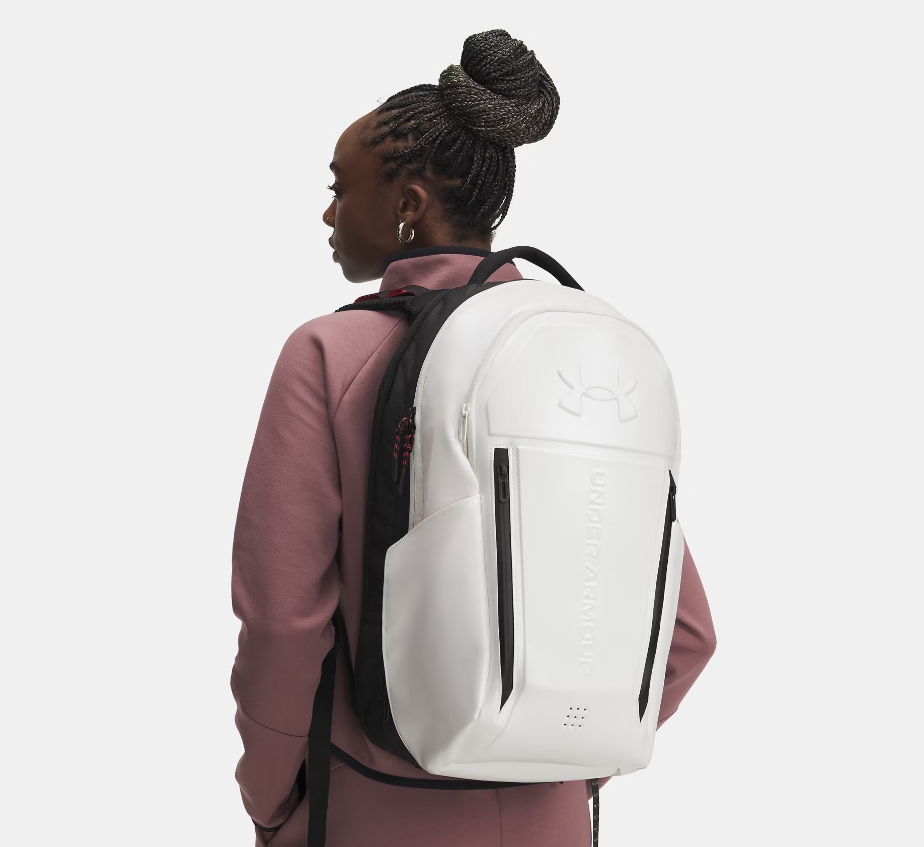 person wearing a white under armour zero weigh backpacl