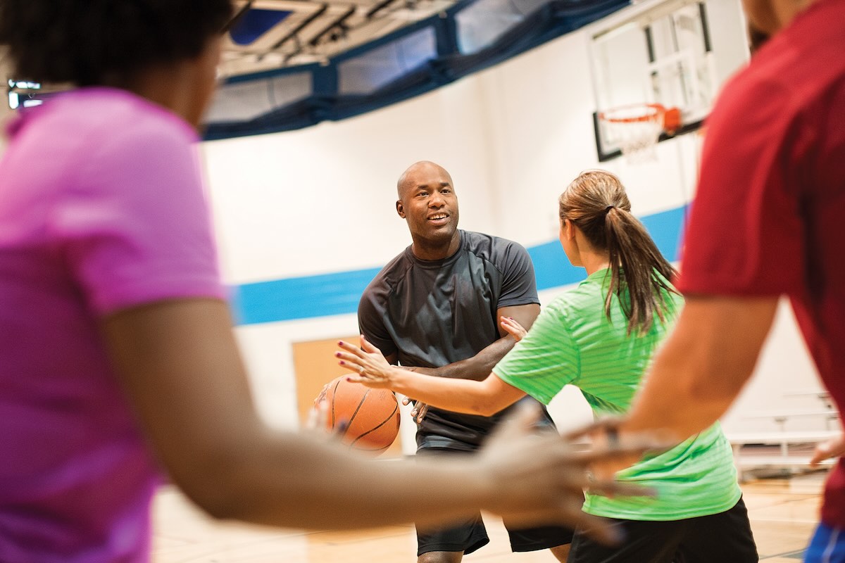 a group of adults playing basketball