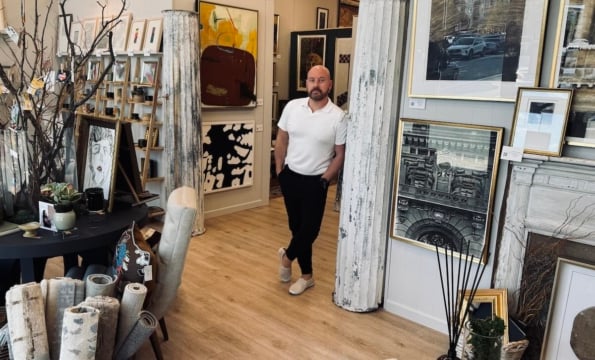 person standing in art gallery surrounded by paintings