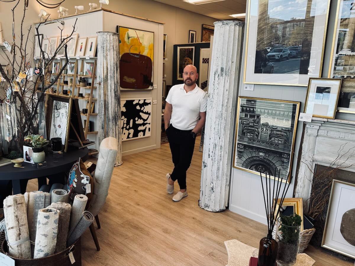 person standing in art gallery surrounded by paintings