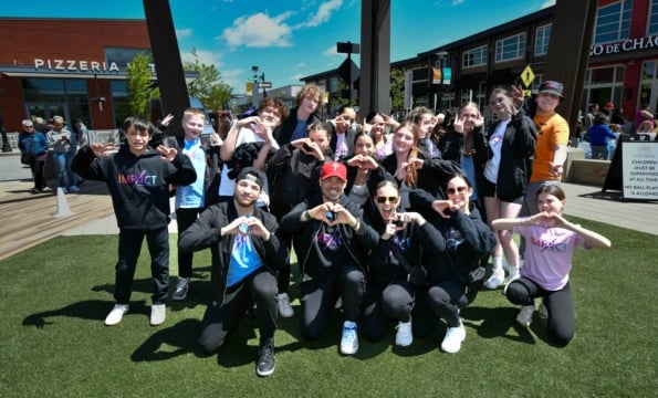Group of people making hearts with their hands outdoors