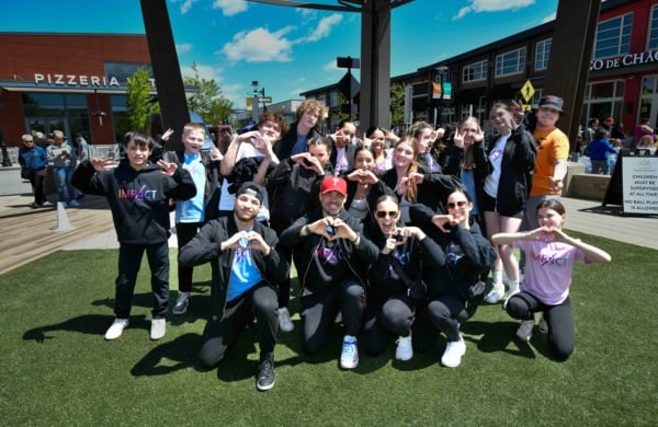Group of people making hearts with their hands outdoors