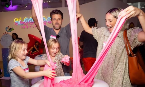 a family playing with pink slime