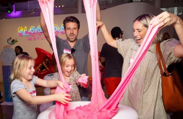 a family playing with pink slime