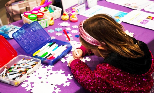 little girl coloring on a snowflake