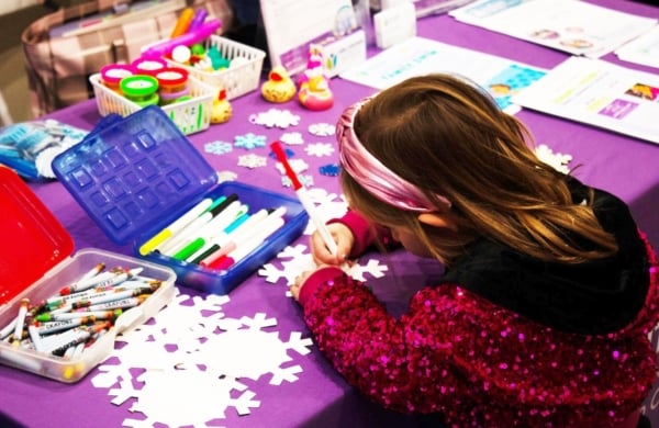 little girl coloring on a snowflake