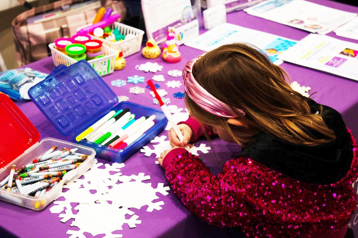 little girl coloring on a snowflake