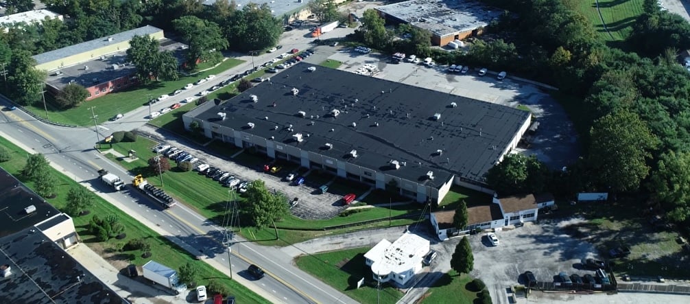 birds eye view of large building and parking lot