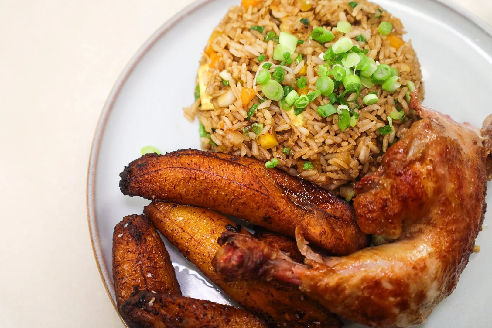 plate of rice, plantains and chicken