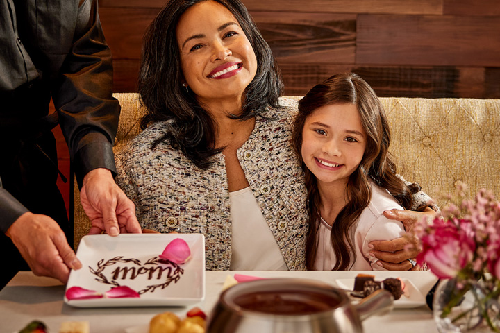 woman smiling next to a little girl