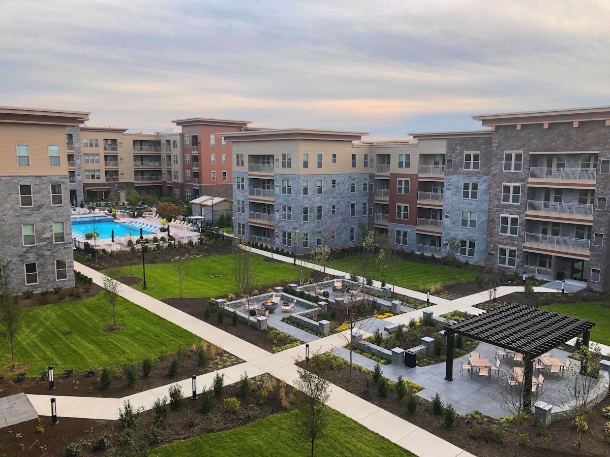 shot of a large apartment complex with pool and outdoor amenities
