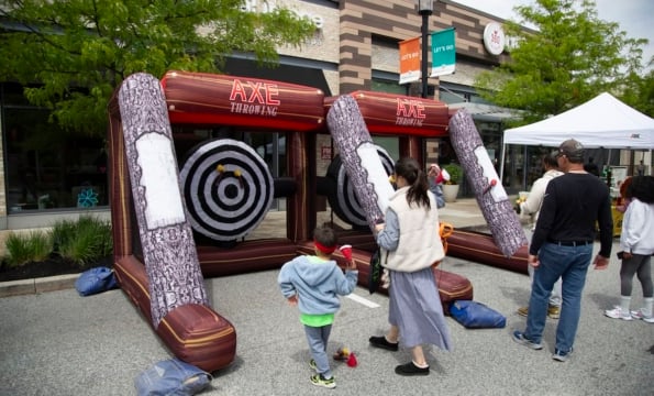 children playing a giant blow up game of axe throwing