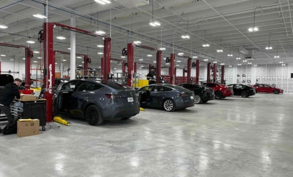 interior of a tesla serive senter with cars parked throughout