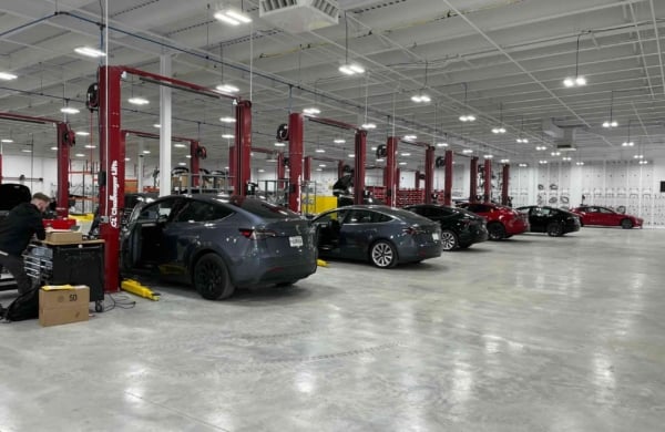 interior of a tesla serive senter with cars parked throughout