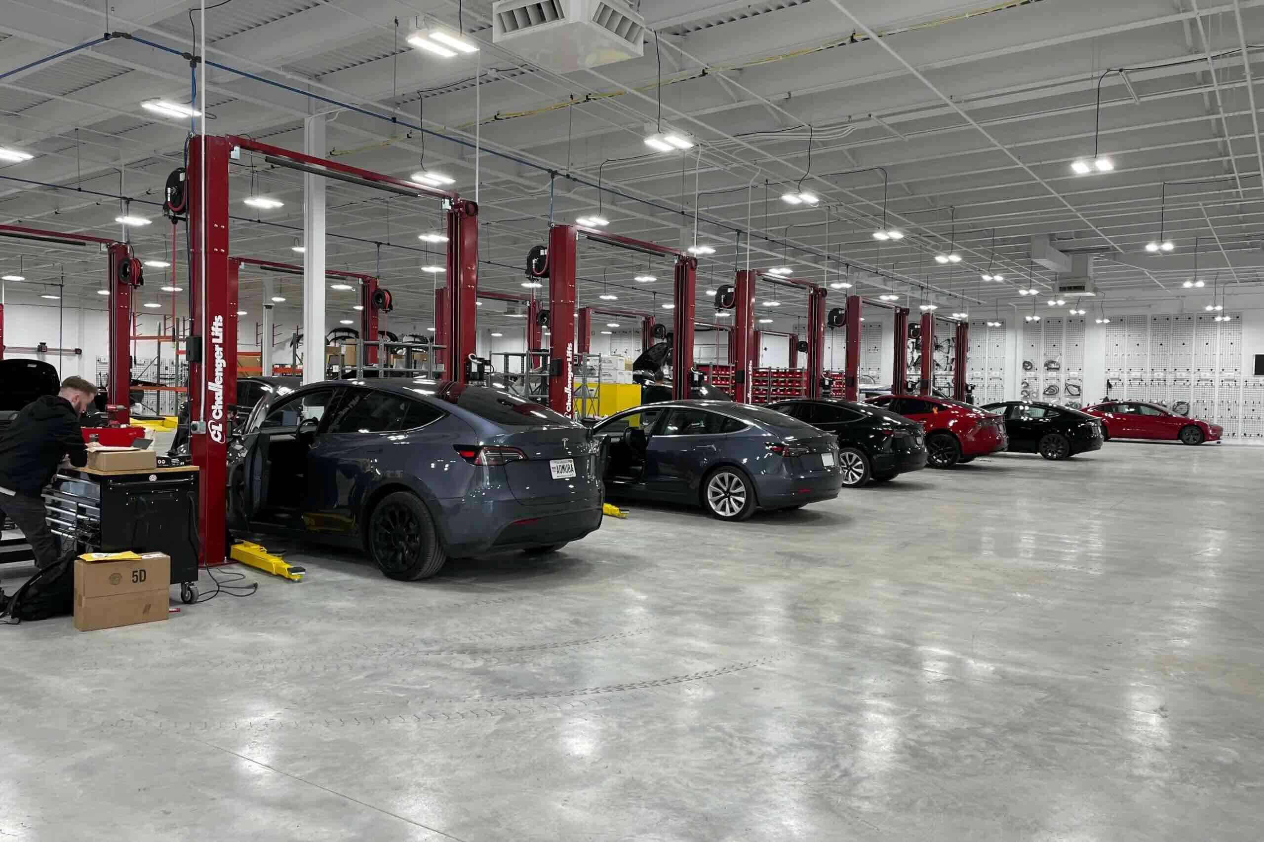 interior of a tesla serive senter with cars parked throughout