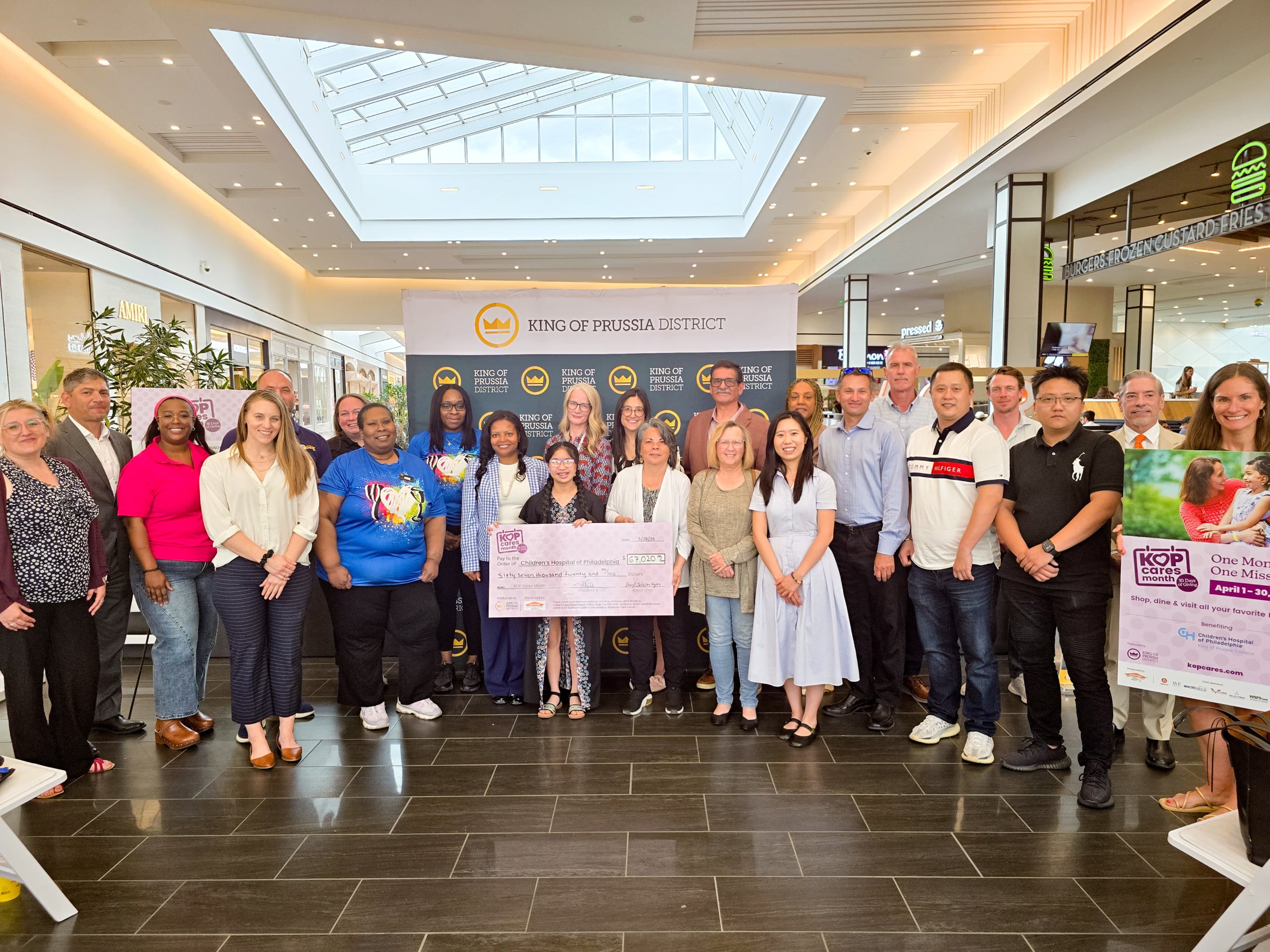 group of people holding a.large check
