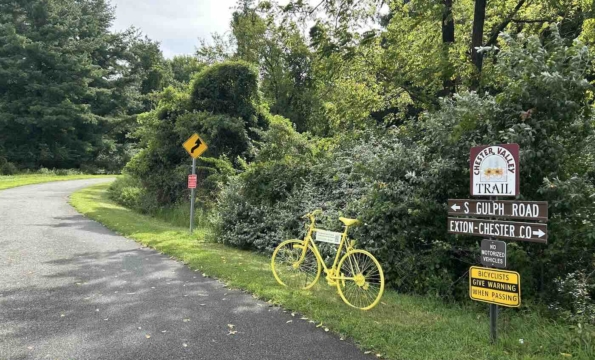 bright yellow bicycle along a path outdoors