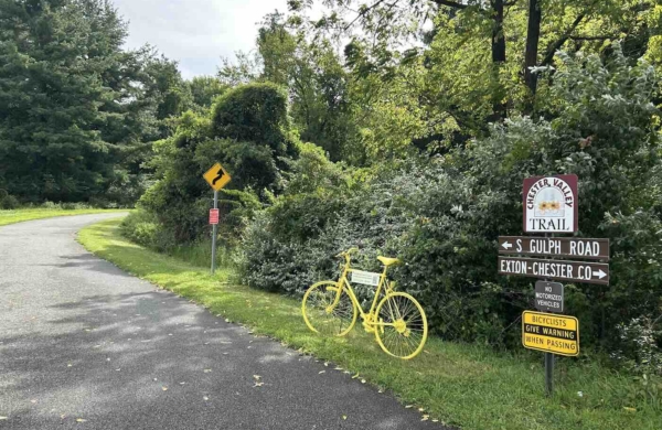 bright yellow bicycle along a path outdoors