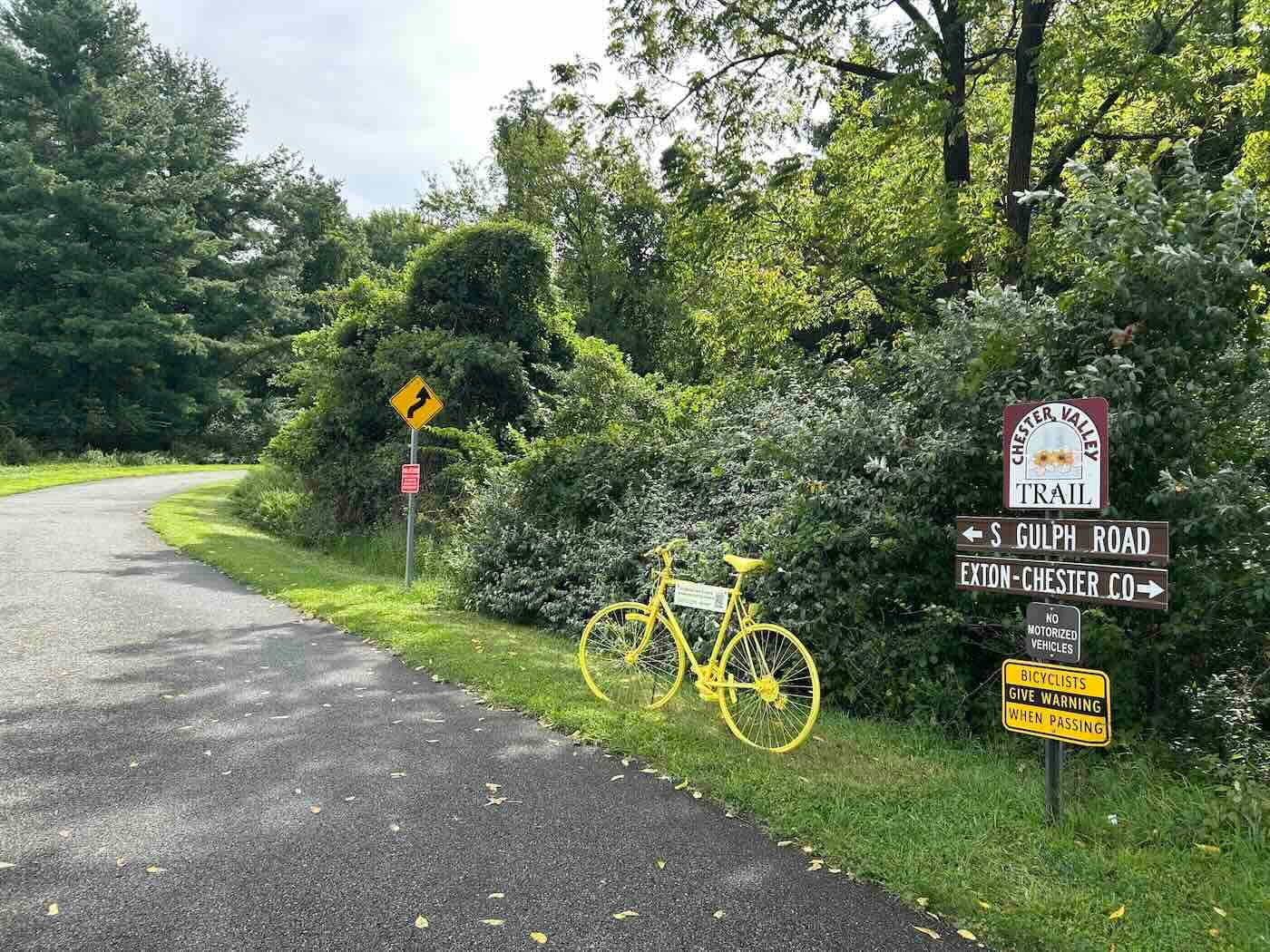 bright yellow bicycle along a path outdoors