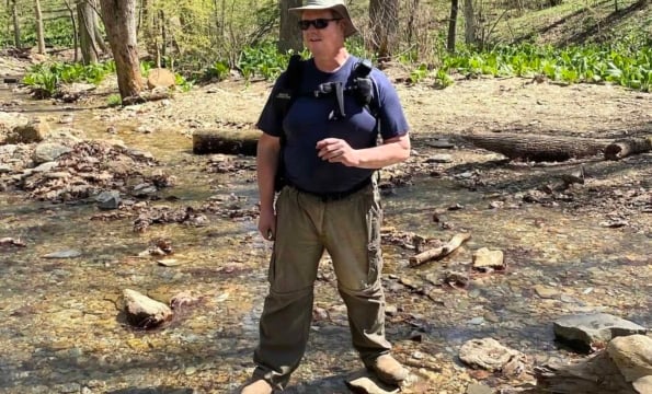 person standing in a creek