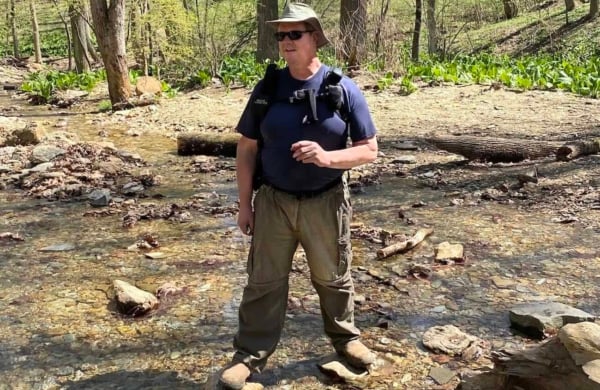person standing in a creek